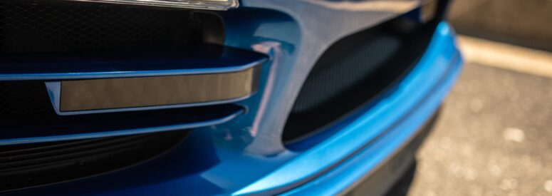 Close up of the front fender of a blue car