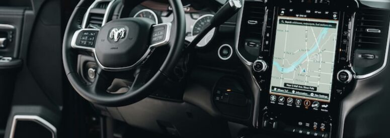 The inside of a RAM vehicle with a giant touch screen navigation instillation