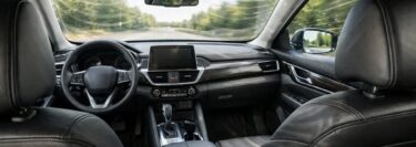 The inside of a vehicle with a view as if you are sitting in the rear left seat