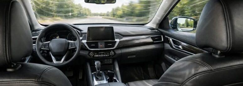 The inside of a vehicle with a view as if you are sitting in the rear left seat